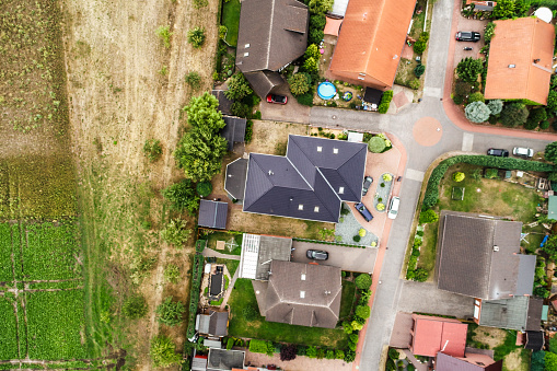 Vertical view from the air with vertical view of houses, roofs and streets of a village in northern Germany.