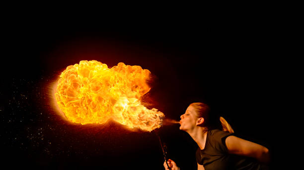 istock Fire breather blowing fire ball from her mouth 1026587762
