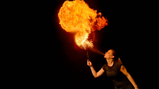 istock Fire breather blowing fire ball from her mouth 1026587768
