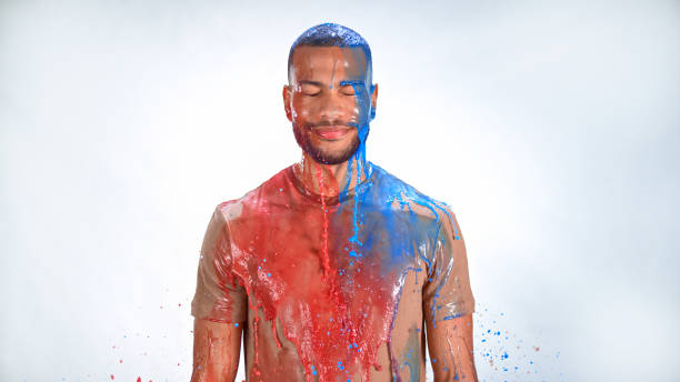Watercolour paints splashing on man