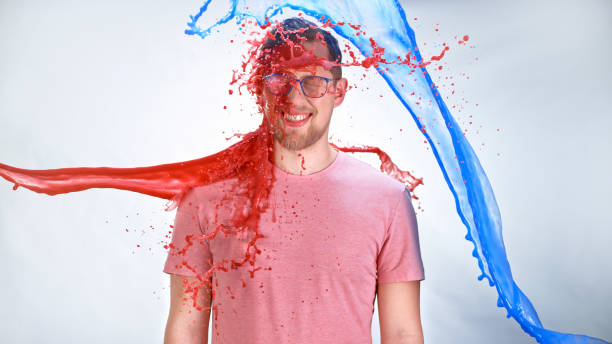 istock Watercolour paints splashing on young man 1026587784
