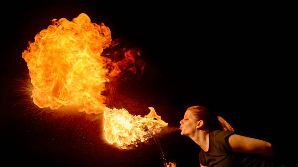 istock Fire breather blowing fire ball from her mouth 1026587794