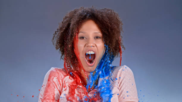 istock Watercolour paints splashing on young woman 1026587868
