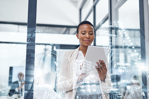 Multiple exposure shot of a mature businesswoman using a digital tablet in a boardroom superimposed on a cityscape