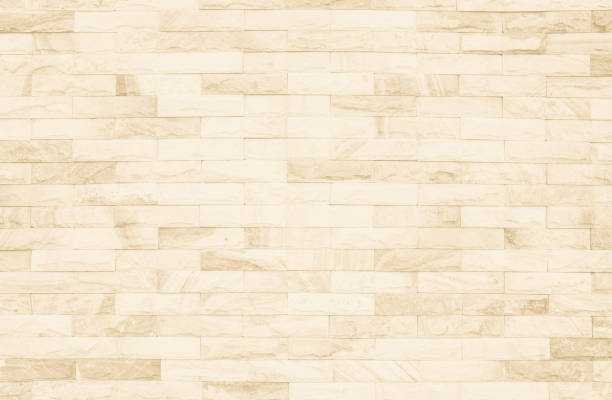 istock Cream and white brick wall texture background. Brickwork or stonework flooring interior rock old pattern clean concrete grid uneven bricks design stack. 1026596614