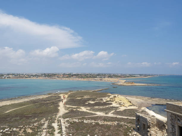 Panoramic view of Sicilian coast from Isola delle Correnti, Portopalo, Sicily - Italy View of the coast from the building of Isola delle Correnti in a sunny day portopalo stock pictures, royalty-free photos & images