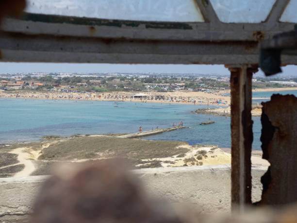 Panoramic view of Sicilian coast from Isola delle Correnti, Portopalo, Sicily - Italy View of the coast from the building of Isola delle Correnti in a sunny day portopalo stock pictures, royalty-free photos & images