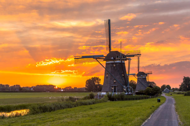 istock Windmills in a row at orange sunset 1026602624