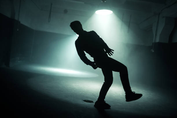 istock Male Dancer Dancing Hip Hop. Silhouette Backlit 1026602946