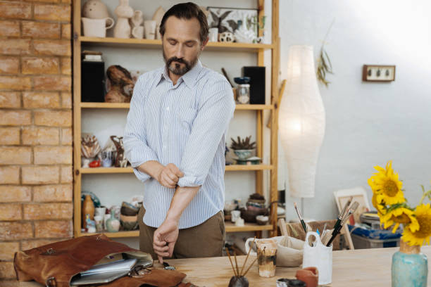 istock Handicraftsman wearing striped shirt coming to work 1026603292