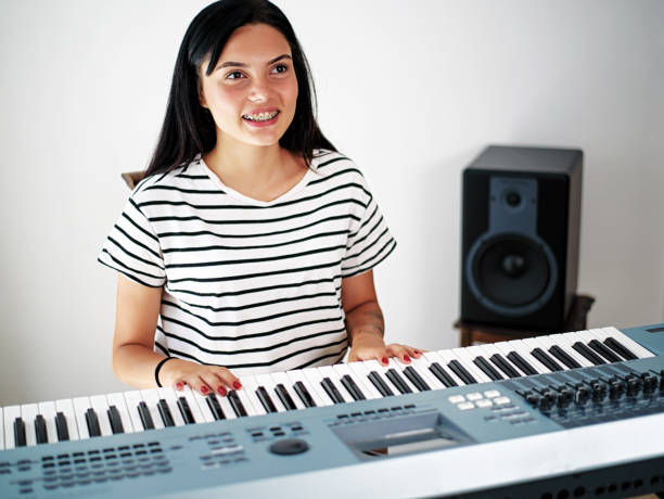istock Young girl playing the piano 1026603318