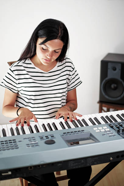 istock Young girl playing the piano 1026606200