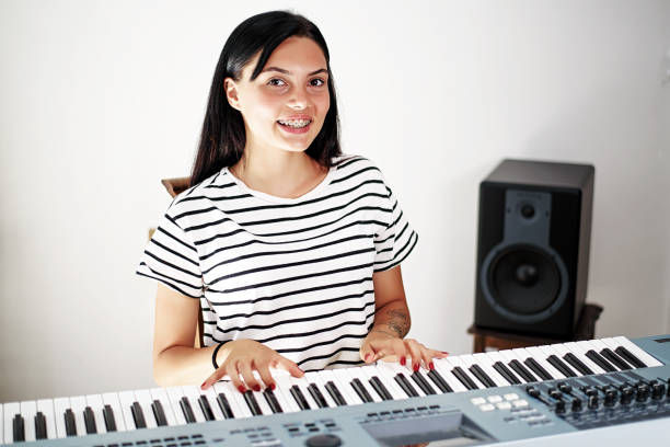 istock Young girl playing the piano 1026606468