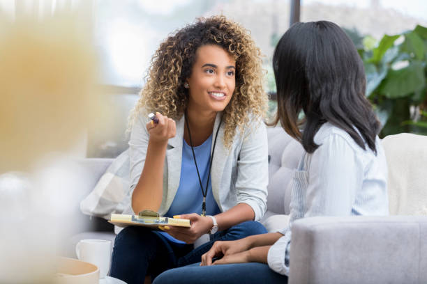 istock Cheerful young therapist talks to client 1026611072