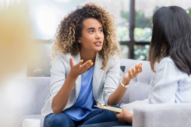 istock Animated young woman talks to therapist 1026611084
