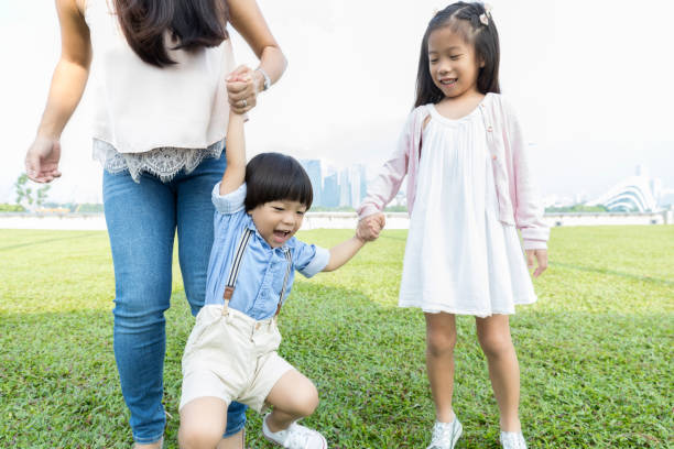 istock Mom plays with her children in park 1026611620