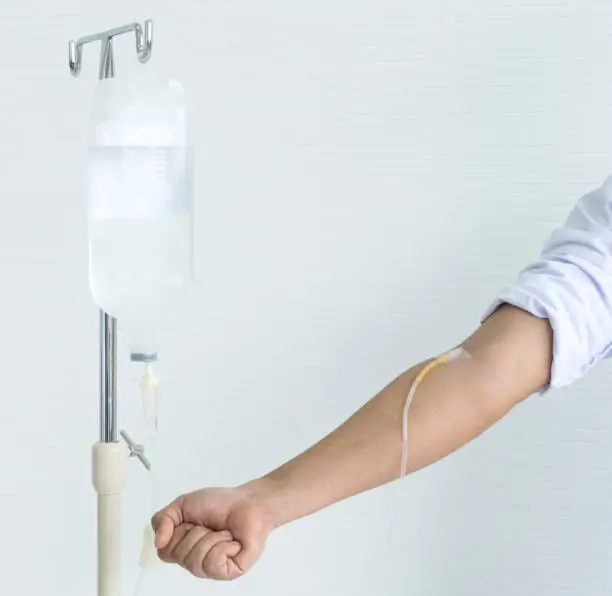 Asian male doctor showing and demonstrate how to infusion drip in doctor class by infusion drip himself on his hand.