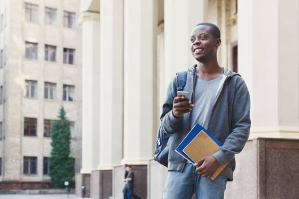 istock Happy african-american student texting in university campus 1026616846