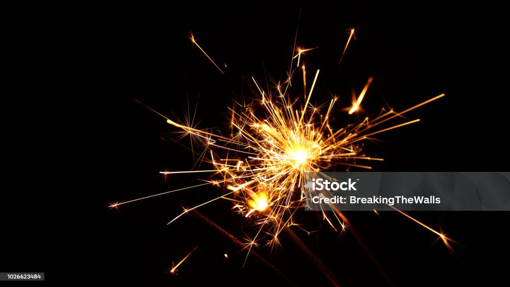 Close up several firework sparklers over black Close up group of several festive firework sparklers over black background, low angle side view, selective focus Sparks Stock Photo