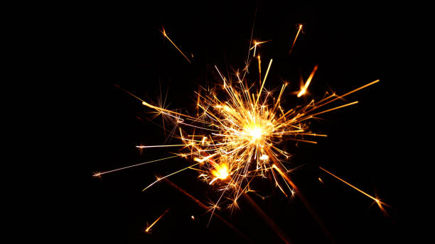 Close up several firework sparklers over black Close up group of several festive firework sparklers over black background, low angle side view, selective focus sparks photos stock pictures, royalty-free photos & images