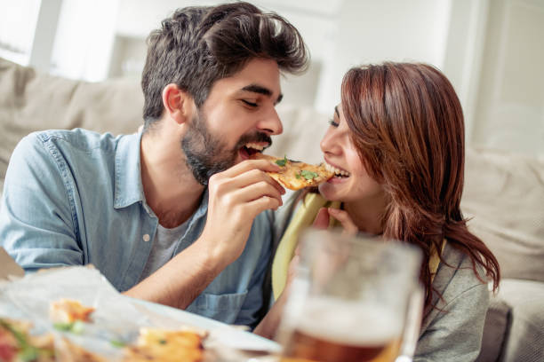 istock Happy young couple enjoying pizza at home 1026624366