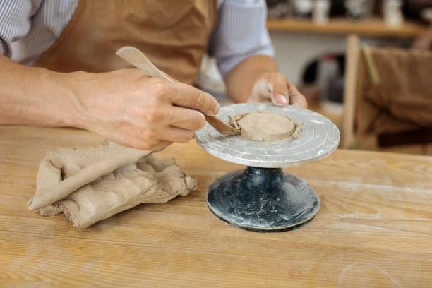 istock Handicraftsman wearing apron forming future clay items 1026624470