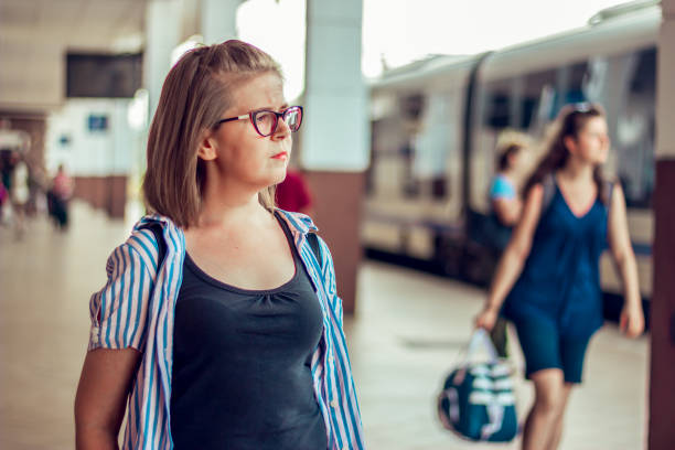 istock Young lady waiting for the train during the day 1026627152