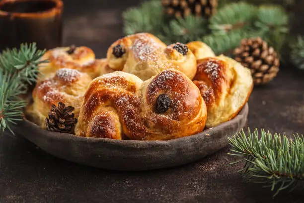 Photo of Traditional Swedish Christmas saffron buns (lussebulle or lussekatt). Swedish christmas.