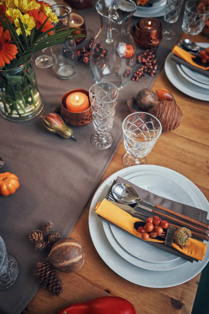 istock Decorated Table for Thanksgiving Dinner with Candles, Pumpkins, Leafs and Nuts 1026631360