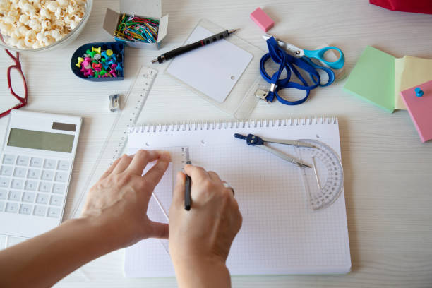 istock Woman draw on messy desk, POV 1026653454