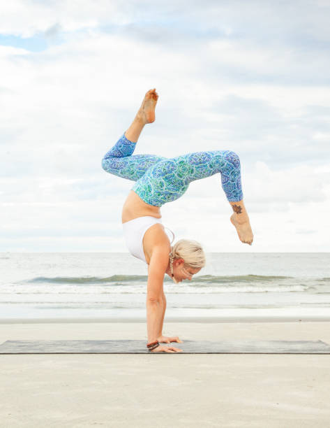 istock Yoga Stag Leg handstand on the Beach, 1026661810
