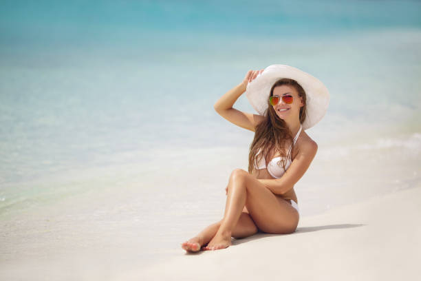 istock Beautiful woman in a bikini on a tropical beach 1026664988