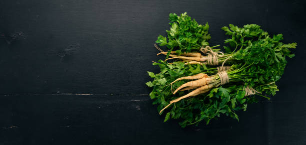 istock Fresh green parsley. Root parsley. On a wooden background. Top view. Copy space. 1026670896