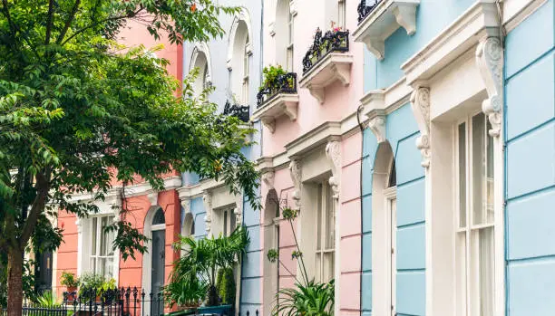 Terraced houses in Camden, London, each painted a different shade of pastel colour.