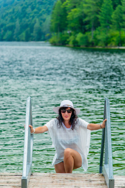 istock Lady in White Pareo at mountain lake 1026676482