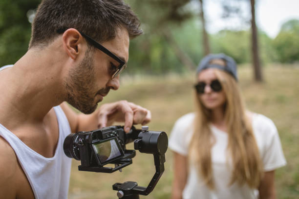 istock Handsome boyfriend preparing a camera for a vlog 1026679168
