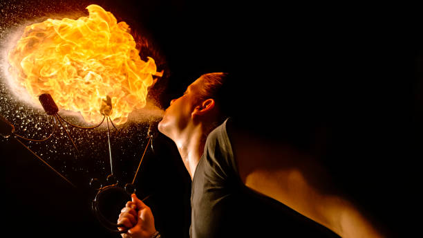 istock Fire breather blowing fire ball from her mouth 1026679704