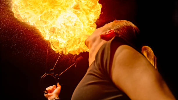 istock Fire breather blowing fire ball from her mouth 1026679710
