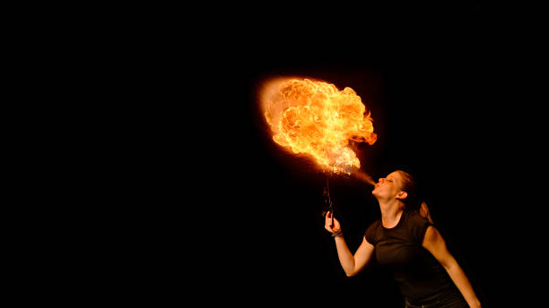 istock Fire breather blowing fire ball from her mouth 1026679720