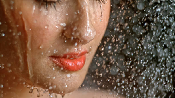 Close-up of woman being splashed with water