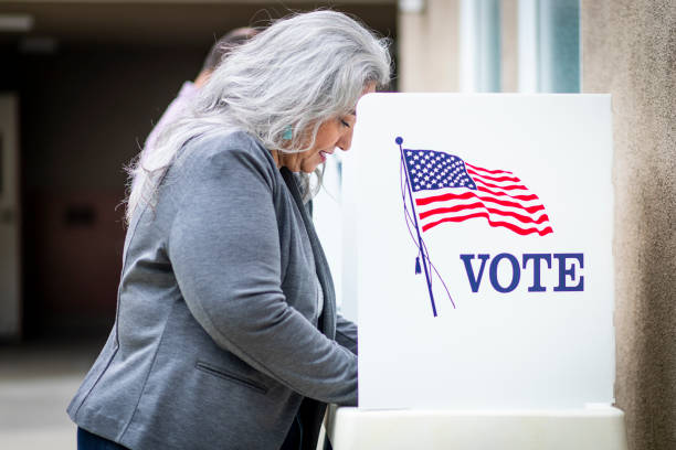 istock Senior Mexican Woman Voting 1026684624