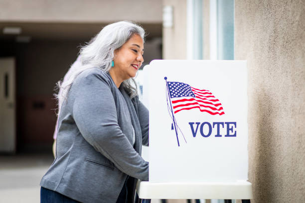 istock Senior Mexican Woman Voting 1026684630
