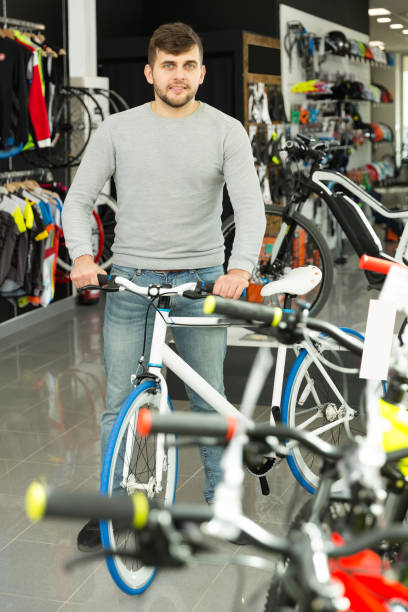 istock male standing with sport bicycle 1026690276