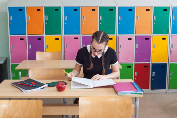 istock Beautiful schoolgirl studying in the classroom 1026690760