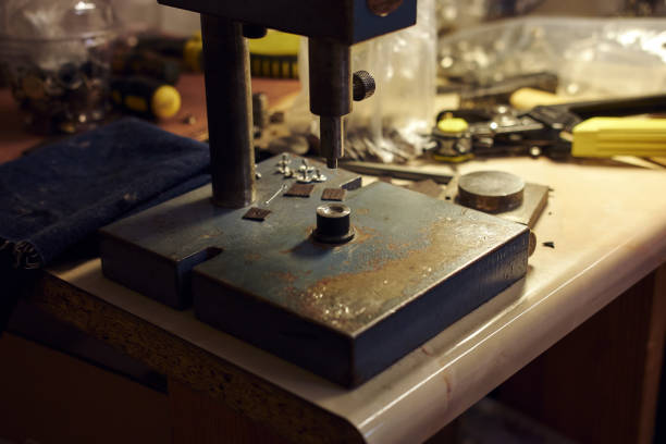 Picture of a tailor's desktop with tools and rivet press. Picture of the tailor's desktop with tools and rivet press riveting stock pictures, royalty-free photos & images