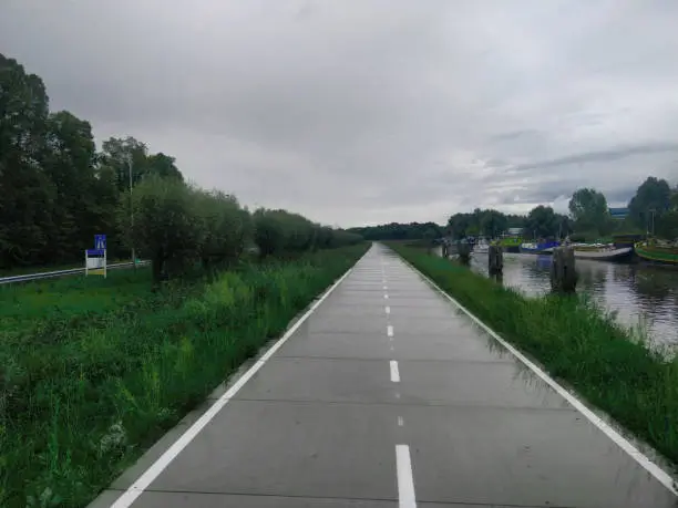 bikelane in the Netherlands next to river and highway
