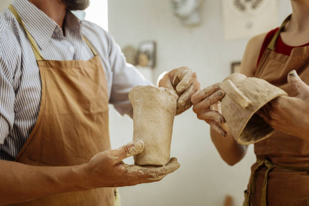 istock Man and woman attending pottery master class together 1026702170