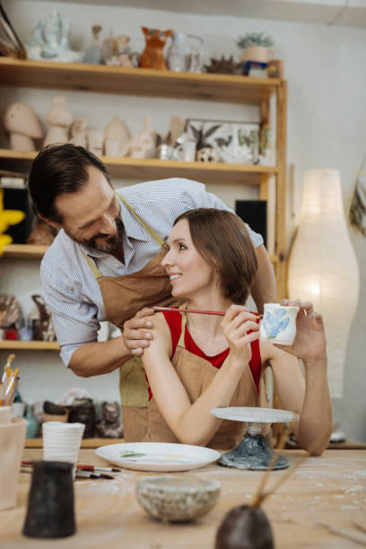 istock Bearded husband hugging his wife working in workroom 1026705424