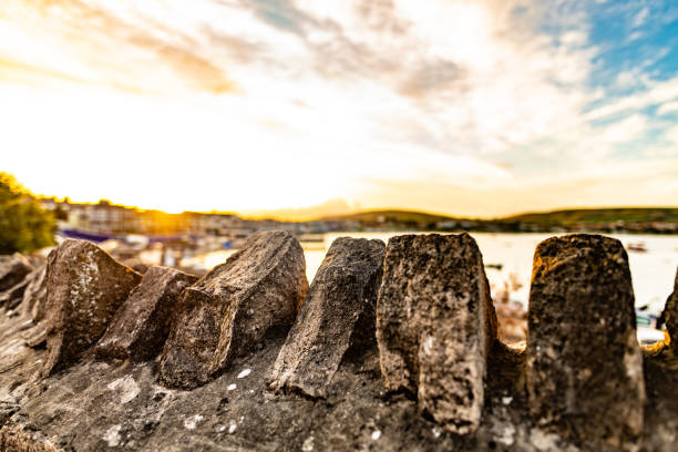 Stone wall with sunset over Swanage in Dorset