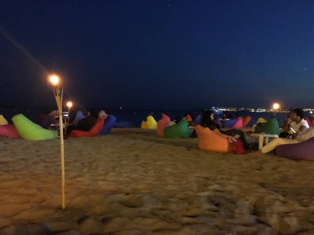 Buyukcekmece, Istanbul, Turkey - August 25, 2018: People are in a restaurant on beach with colorful cushions.